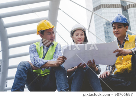 Civil Construction engineer teams shaking hands together wear work helmets worker on construction site. Foreman industry project working engineer teamwork. Two asian engineer team shake hands together Civil Construction engineer teams shaking hands together wear work helmets worker on construction site. Foreman industry project working engineer teamwork. Two asian engineer team shake hands together 98705697