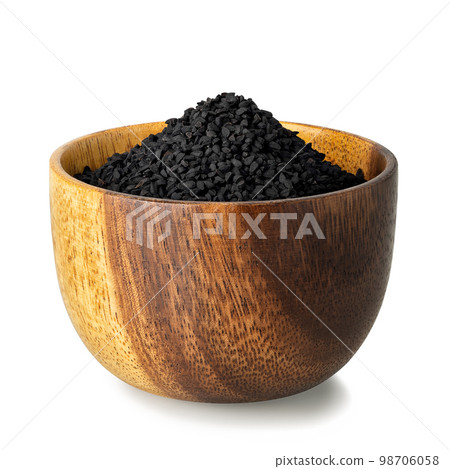 black cumin seeds in wooden bowl isolated on white black cumin seeds in wooden bowl isolated on white 98706058