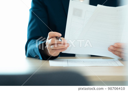 Personnel officer looking at application documents Personnel officer looking at application documents 98706410