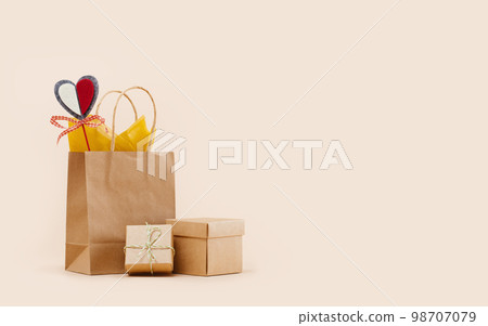 Fall Gift or Sale concept. Shopping paper bag, with gift boxes mockup red felt heart Valentines day tag. Copy space. Thanksgiving. Packaging. Box order delivery. Thank you 98707079