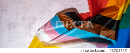 Banner Rainbow LGBTQIA flag made from silk material on concrete background with copy space for your text. Valentine's Day greeting card. Symbol of LGBTQ pride month. Equal rights. Peace and freedom Banner Rainbow LGBTQIA flag made from silk material on concrete background with copy space for your text. Valentine's Day greeting card. Symbol of LGBTQ pride month. Equal rights. Peace and freedom 98708335