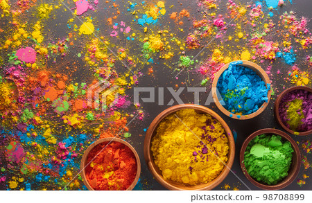 Happy Holi decoration, the indian festival.Top view of colorful holi powder on dark background. 98708899