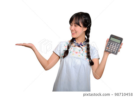 Portrait of beautiful young asian woman in denim dress holding calculator on white background. business shopping online concept. Portrait of beautiful young asian woman in denim dress holding calculator on white background. business shopping online concept. 98710458