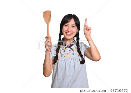 Portrait of beautiful young asian woman smile in denim dress with spatula on white background 98710472