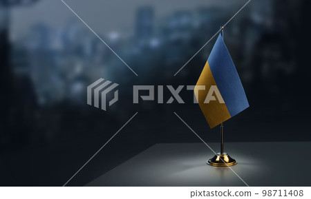 A small Ukraine flag on an abstract blurry background 98711408