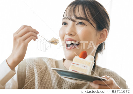 A woman eating short cake A woman eating short cake 98711672