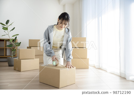 Young woman doing packing work moving image 98712190