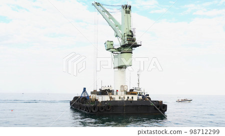 Floating marine crane in Odessa Black Sea. Offshore crane for loading goods in dry bulk cargo ships. Floating marine crane in Odessa Black Sea. Offshore crane for loading goods in dry bulk cargo ships. 98712299