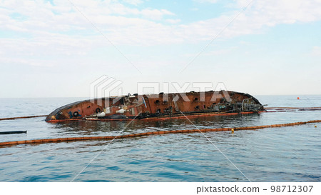 Sunken drowned tanker ship near the aground. Broken rusty ship on the shallow water. Sunken drowned tanker ship near the aground. Broken rusty ship on the shallow water. 98712307