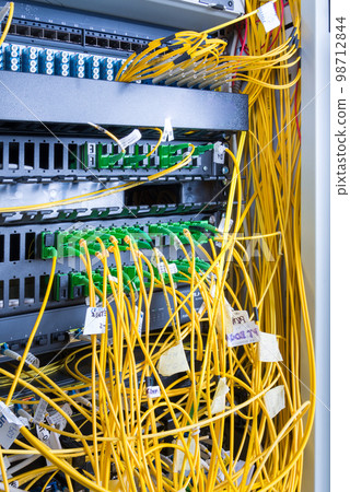 fiber optic cables plugged in network switch panel inside data center fiber optic cables plugged in network switch panel inside data center 98712844