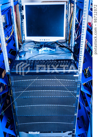 rack with hard disks used for data storage with computer and keyboard 98712872