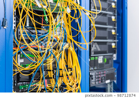 Server rack with fiber optic cables attached to front panel switch ports Server rack with fiber optic cables attached to front panel switch ports 98712874