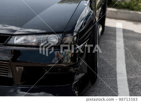 Modern car headlight close up. 98713383