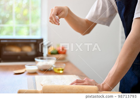 Close-up image, A male baker making dough on the kitchen table, preparing raw dough 98713793