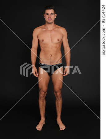 Handsome man in underwear on black background Handsome man in underwear on black background 98714424