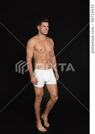 Handsome man in underwear on black background 98714432