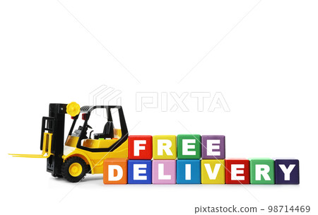 Toy forklift and cubes with words FREE DELIVERY isolated on white. Logistics and wholesale concept Toy forklift and cubes with words FREE DELIVERY isolated on white. Logistics and wholesale concept 98714469