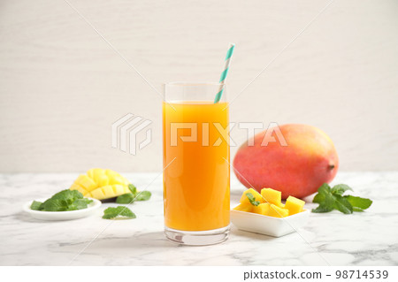 Fresh delicious mango drink on marble table 98714539