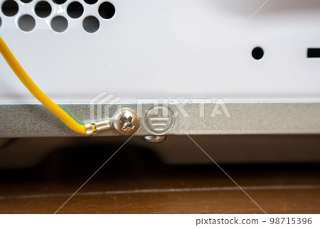 Ground wire or earth wire behind a Japanese model microwave oven. 98715396
