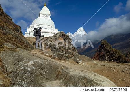 Hiker woman posing with mountains at background Hiker woman posing with mountains at background 98715706
