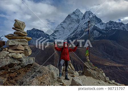 Hiker woman posing with mountains at background 98715707