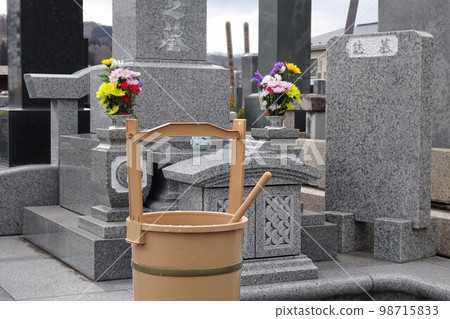 An image of visiting a grave Grave, flowers and a pail An image of visiting a grave Grave, flowers and a pail 98715833