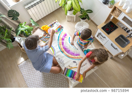 Happy young grandmother draw art picture playing grandson and granddaughter enjoy family weekend 98715894