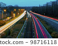 Long exposure light trails of evening city traffic 98716118