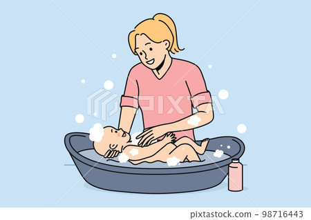Smiling mother washing newborn baby Smiling mother washing newborn baby 98716443