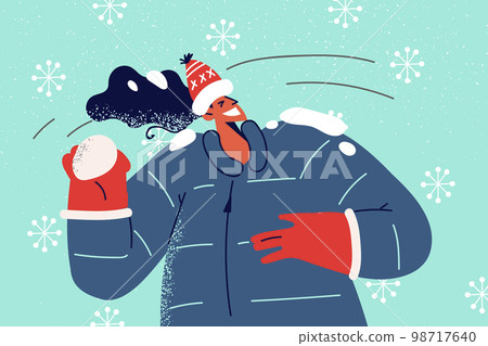 Smiling woman play snowballs  98717640