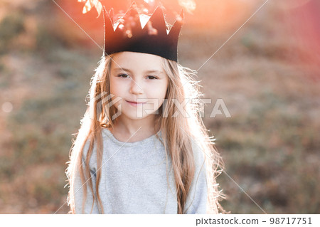 Pretty kid girl 4-5 year old wearing stylish autumn clothes in park.  Looking at camera. Fall season. Childhood. Stock Photo