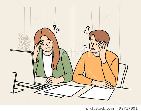 Unhappy couple confused with paper bills  98717901