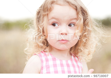 Cute baby girl 2-3 year old posing outdoors. Looking away. Childhood. Cute baby girl 2-3 year old posing outdoors. Looking away. Childhood. 98718007