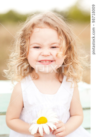 Baby girl 2-3 year old playing the ape outdoors. Looking at camera. Childhood. Baby girl 2-3 year old playing the ape outdoors. Looking at camera. Childhood. 98718009
