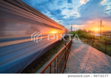 High speed train in motion on the railway station at sunset 98718177