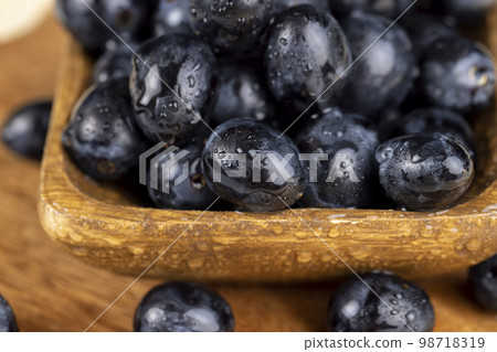 sweet ripe black grapes covered with drops of water sweet ripe black grapes covered with drops of water 98718319