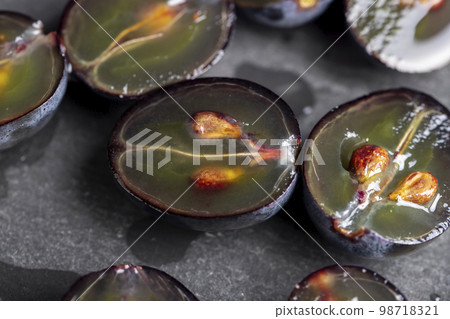 sweet ripe black grapes cut in half sweet ripe black grapes cut in half 98718321