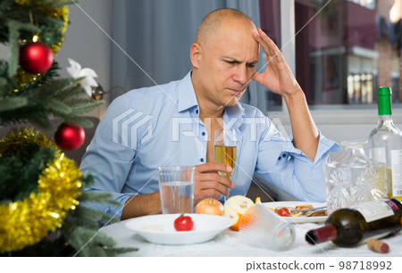 Upset man at the New Year table 98718992