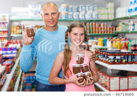 cheerful father doing shopping with preteen girl in supermarket 98719069