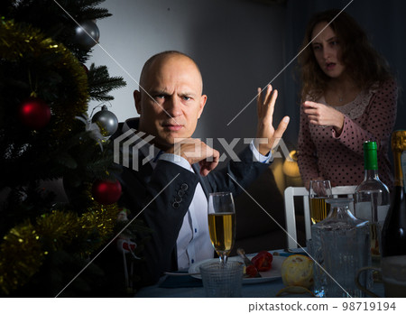 Couple quarreling at Christmas night 98719194