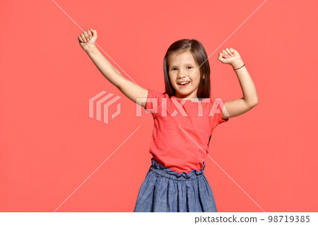 Close-up studio shot of beautiful brunette little girl posing against a pink background. Close-up studio shot of beautiful brunette little girl posing against a pink background. 98719385