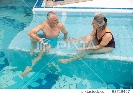 Seniors spending a day at the swimming pool nad looking relaxed 98719407