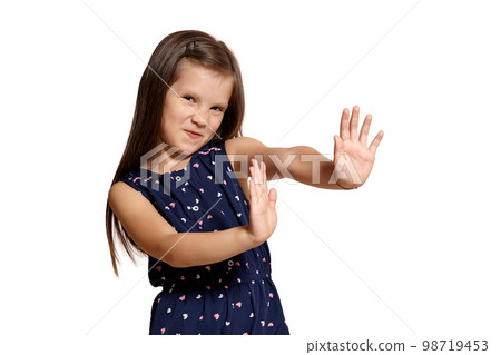 Close-up studio shot of beautiful brunette little girl posing isolated on white studio background. Close-up studio shot of beautiful brunette little girl posing isolated on white studio background. 98719453