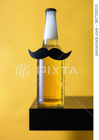 Bottle of beer with moustache. Movember. Concept of father's day, bachelor party. Bottle of beer with moustache. Movember. Concept of father's day, bachelor party. 98720010