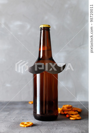 Bottle of beer with moustache. Movember. Concept of father's day, bachelor party. 98720011
