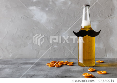 Bottle of beer with moustache. Movember. Concept of father's day, bachelor party. Bottle of beer with moustache. Movember. Concept of father's day, bachelor party. 98720015