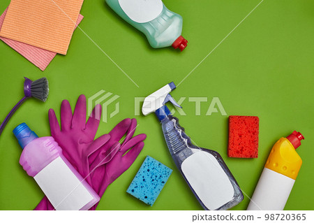 Detergents and cleaning accessories on a green background. Housekeeping concept. Detergents and cleaning accessories on a green background. Housekeeping concept. 98720365