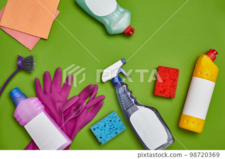 Detergents and cleaning accessories on a green background. Housekeeping concept. 98720369