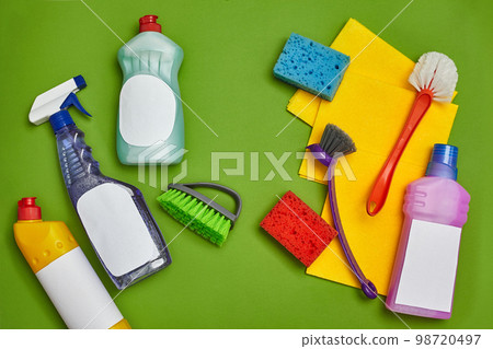 Detergents and cleaning accessories on a green background. Housekeeping concept. Detergents and cleaning accessories on a green background. Housekeeping concept. 98720497