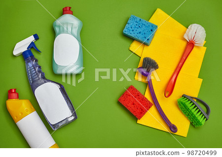 Detergents and cleaning accessories on a green background. Housekeeping concept. Detergents and cleaning accessories on a green background. Housekeeping concept. 98720499